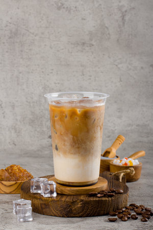 Boba or tapioca pearls is taiwan bubble milk tea in plastic cup with coffee flavor on texture  background, summers refreshment.の写真素材