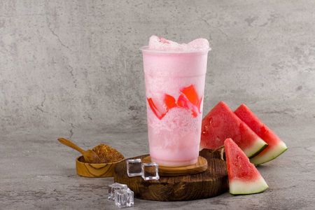 Boba or tapioca pearls is taiwan bubble milk tea in plastic cup with watermelon flavor on texture  background, summers refreshment.の写真素材