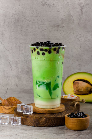 Boba or tapioca pearls is taiwan bubble milk tea in plastic cup with Avocado flavor on texture  background, summers refreshment.の写真素材