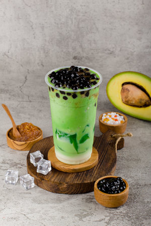 Boba or tapioca pearls is taiwan bubble milk tea in plastic cup with Avocado flavor on texture  background, summers refreshment.の写真素材