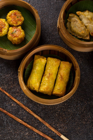 Fried Dumplings in Bamboo Baskets on Dark Backgroundの写真素材