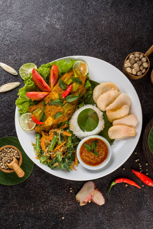 Thai food, Spicy curry chicken with rice and vegetables on black backgroundの写真素材
