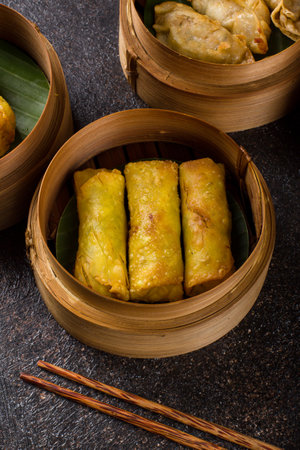 Fried Dumplings in Bamboo Basket on Dark Background.の写真素材