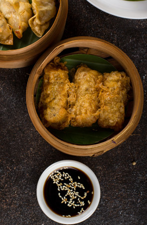 Fried Dumplings in Bamboo Basket on Dark Background.の写真素材