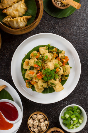 Stir Fried Dumpling with Vegetables and Spices on Black Backgroundの写真素材
