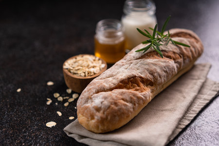 Fresh homemade artisan loaf of baguette breads on rustic background with copy space. sourdough mini baguette breads.の写真素材
