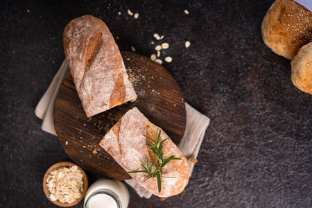 Fresh homemade artisan loaf of baguette breads on rustic background with copy space. sourdough mini baguette breads.の写真素材