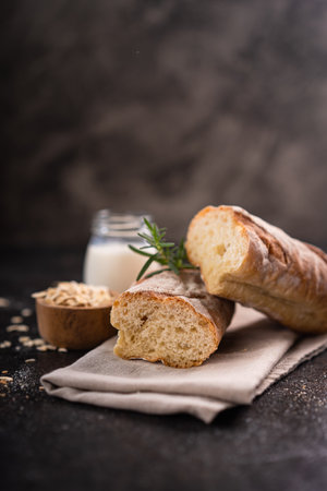 Fresh homemade artisan loaf of baguette breads on rustic background with copy space. sourdough mini baguette breads.の写真素材