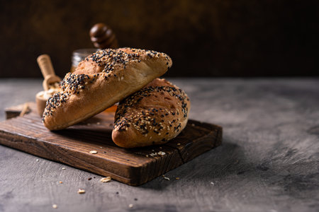 Fresh homemade bread whole wheat baguette on napkin and abstract table. Sourdough breadの写真素材