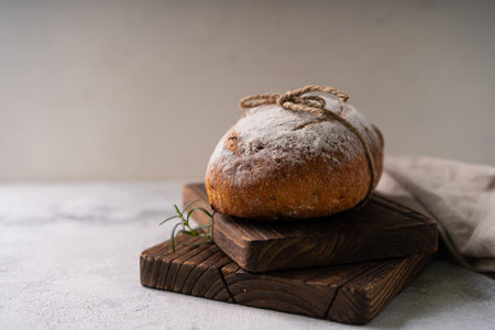 Fresh organic homemade artisan ciabatta bread with herbs, olive oil and olives on white rustic...