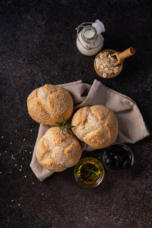 The homemade sourdough sesambrÃ¶tchen bread buns with sesame seeds. Artisan bakery