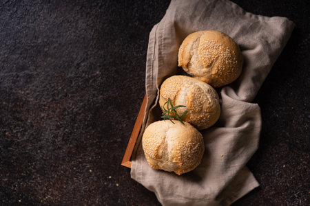 The homemade sourdough sesambrÃ¶tchen bread buns with sesame seeds. Artisan bakery