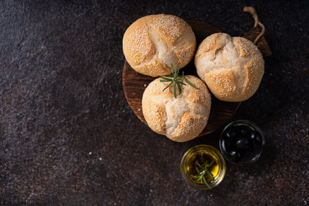 The homemade sourdough sesambrÃ¶tchen bread buns with sesame seeds. Artisan bakery