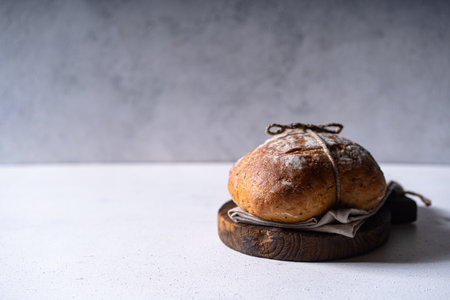 Freshly baked sourdough ciabatta bread with olives and rosemary on a white abstract table. Artisan breadの写真素材