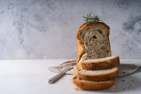 Fresh Sliced Homemade Wholegrain Wheat Bread on white rustic background. Artisan Sourdough