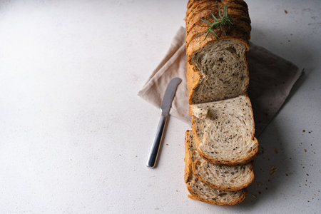Fresh Sliced Homemade Wholegrain Wheat Bread on white rustic background. Artisan Sourdough
