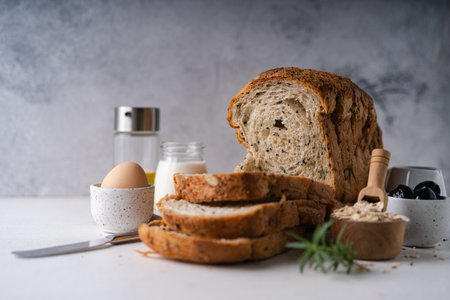 Fresh Sliced Homemade Wholegrain Wheat Bread on white rustic background. Artisan Sourdough