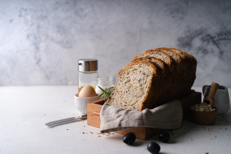 Fresh Sliced Homemade Wholegrain Wheat Bread whit olive oil on white rustic background. Artisan Sourdoughの写真素材