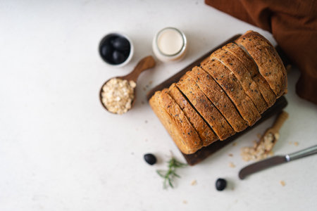 Fresh Sliced Homemade Wholegrain Wheat Bread whit olive oil on white rustic background. Artisan Sourdoughの写真素材
