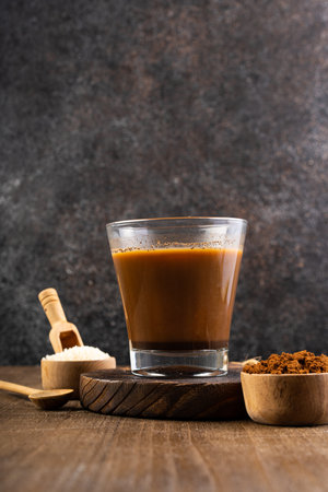 Coffee in a glass on a wooden background. Selective focus.の写真素材