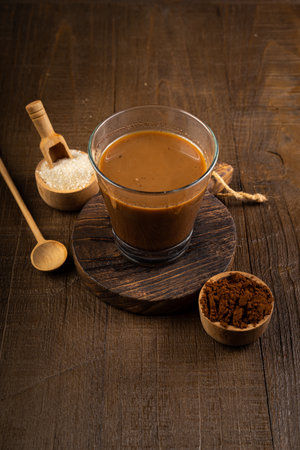 Coffee with milk in a glass on a wooden background.の写真素材