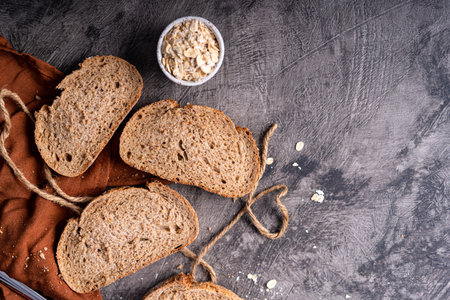 Fresh slices of home baked artisan sourdough bread on white rustic dark background. german rye breadの写真素材