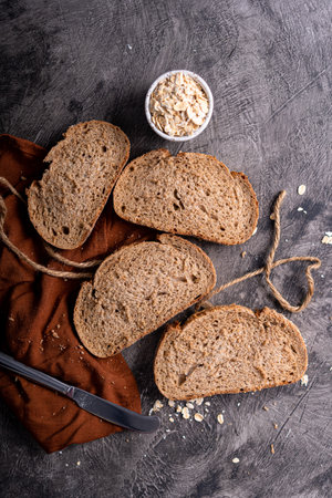 Fresh slices of home baked artisan sourdough bread on white rustic dark background. german rye breadの写真素材