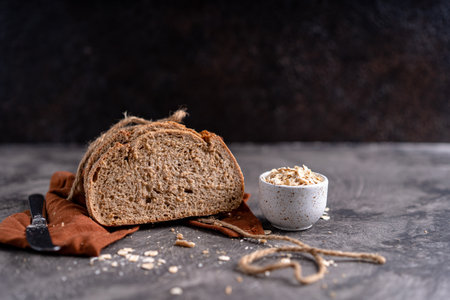 Fresh slices of home baked artisan sourdough bread on white rustic dark background. german rye breadの写真素材
