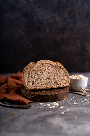 Fresh slices of home baked artisan sourdough bread on white rustic dark background. german rye breadの写真素材