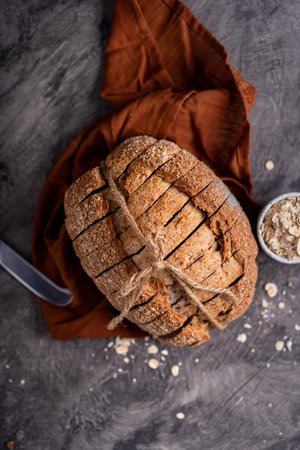 Fresh slices of home baked artisan sourdough bread on white rustic dark background. german rye breadの写真素材