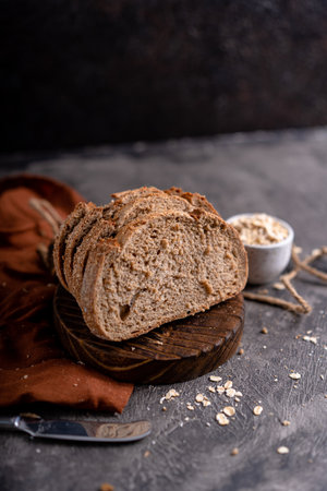Fresh slices of home baked artisan sourdough bread on white rustic dark background. german rye breadの写真素材