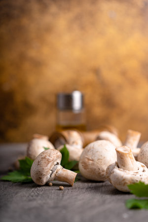 Raw white mushrooms champignons and pepper on grey background for cooking fresh ingredients. free copy spaceの写真素材