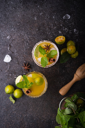 Classic lime margarita cocktail with ice and mint, top view