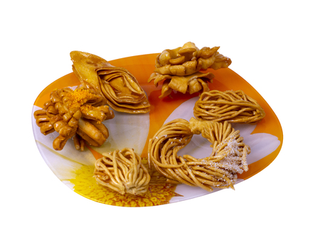 honey cookies of different shapes laid out on a dish, white backgroundの写真素材