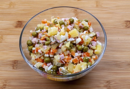 Vegetable salad Olivier in a glass bowl. Healthy fresh vegan food.の写真素材