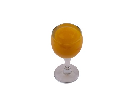 Summer cold drinks: homemade peach juice with a slice of peeled peach in a glass in its own juice on a white backgroundの写真素材