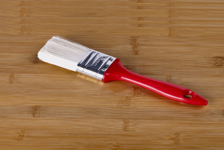 tassel witassel with red handle lies on a wooden boardth red handle lies on a wooden boardの写真素材
