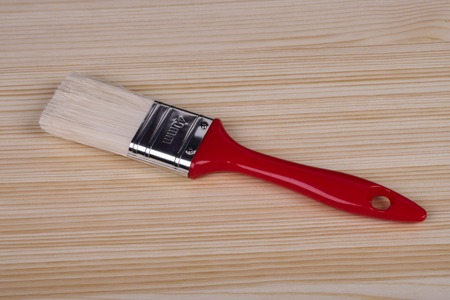 tassel witassel with red handle lies on a wooden boardth red handle lies on a wooden boardの写真素材