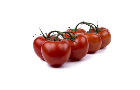 red tomatoes on a twig isolated on white backgroundの写真素材