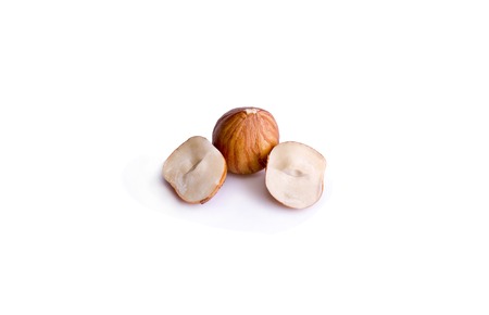 peeled hazelnut in a cut on a white backgroundの写真素材