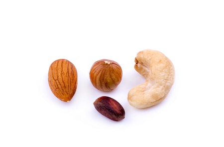 almond, hazelnut, cashew and pine nut on a white backgroundの写真素材