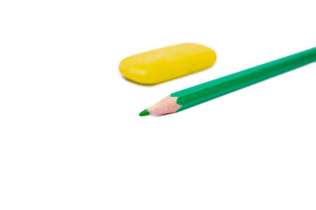 green sharpened pencil and yellow eraser on a white background, the object is isolated on a white backgroundの写真素材