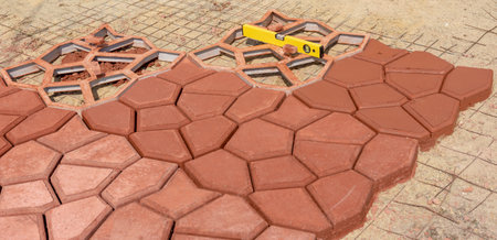 making paving slabs using molds with your own hands, the photo was taken on the street on a sunny...