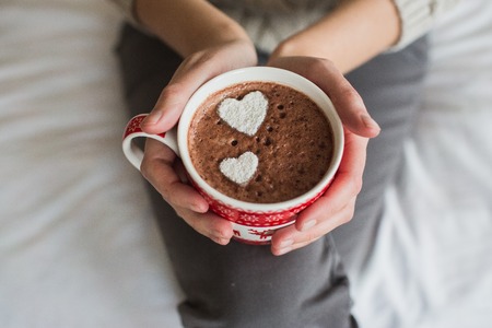 Woman hands holding a Cup of hot cocoa or  chocolate for  background, traditional drink  the winter time, lifestyle photos, top view, Valentines dayの写真素材