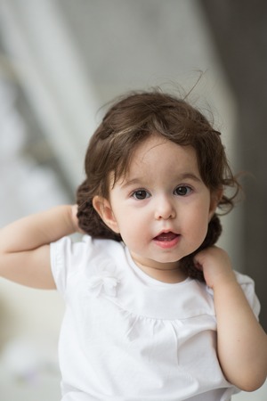 Happy little girl with brown hatの写真素材