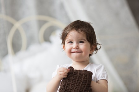 Happy little girl with brown hatの写真素材