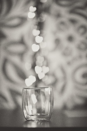 small white hearts falling in glass on white backgroundの写真素材