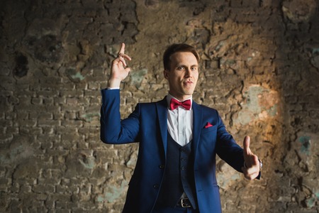 young businessman in blue suit emotional posingの写真素材