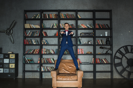young businessman in blue suit emotional posingの写真素材