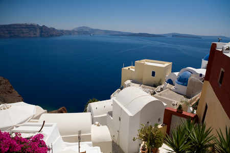 Santorini, Greece - blue sea, blue sky and pink flowersの写真素材